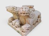 a statue of a lion and a bear on a white surface