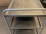 two stainless steel trays are stacked on top of each other in a kitchen