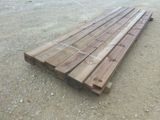 a pile of wood sitting on the ground in the dirt