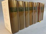 six books are lined up in a row on a table