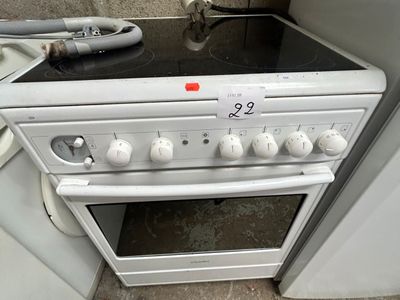 a white stove top oven sitting in a kitchen next to a washer and dryer