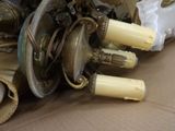 a pile of antique lamps sitting on a cardboard box