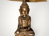 an image of a buddha statue with a lamp on top of it