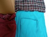 three pairs of men ' s shorts sitting on top of a cardboard box