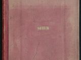 un vieux livre à la couverture rose posé sur une table