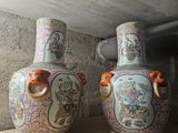 two vases sitting on a shelf in a room