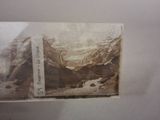 an old photo of a mountain with a river in it