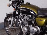 a motorcycle that is parked in a garage next to a wall
