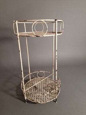 an image of a white metal shelf with a basket on top