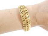 bracelet on a woman ' s arm with a gold chain bracelet