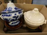 two blue and white dishes in a box on a table