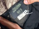 the label on the top of a black dress is being held by a woman