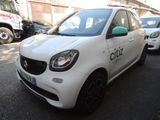 a white smart car parked on the side of the street