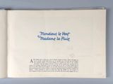 an open book with blue writing on it on a blue surface