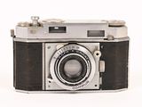 an old camera that is sitting on a white surface