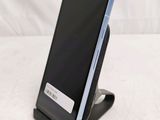 a phone that is sitting on a stand on a table