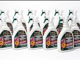 five bottles of liquid are lined up on a white surface