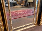 a large mirror sitting on the floor in a room