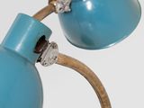 a blue lamp that is on a wooden stand