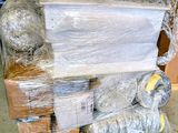 a large pile of plastic wrapped items on top of a pallet