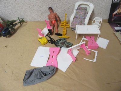 a doll sitting on a table next to a chair and other toys