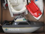 a toy boat in a box with other toy boats