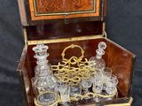 a wooden box with a set of glasses in it