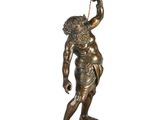 an image of a bronze statue of a man holding a candle