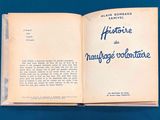 an open book with blue writing on it on a blue surface