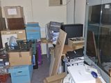 a room filled with boxes and a television in it