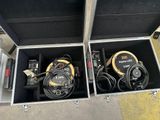 two air compressors in a case on the ground