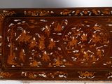 a wooden tray with a design on it on a table