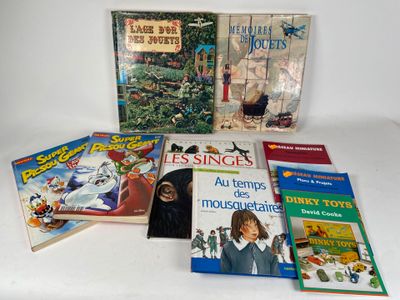 several children ' s books are sitting on a white surface