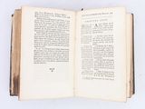 an open book on a white surface with a white background