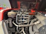 a close up view of a car engine with its hood open