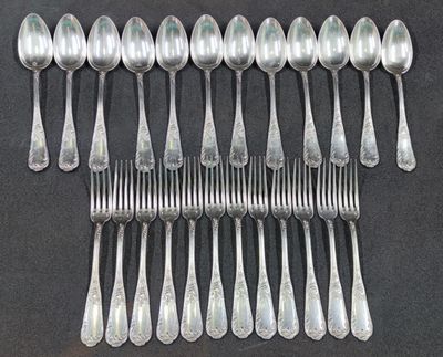 a lot of silver spoons and spoons on a table
