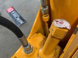 a close up of a yellow machine with a black hose