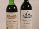 two bottles of wine sitting next to each other on a table