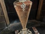 a vase that is sitting on the floor in front of a door