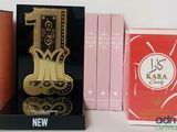 three different perfumes on display in a display case