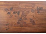 a wooden cutting board with a design of leaves on it