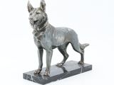 statue of a dog standing on a marble base on a white background