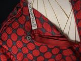 a red and black dress on a mannequin on a mannequin stand