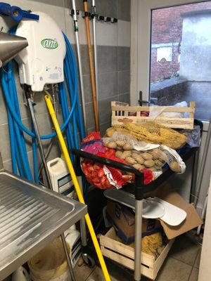 a kitchen with a bunch of food on a cart
