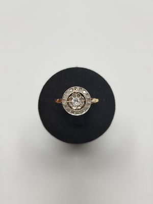 a close up of a diamond ring on a black ring stand