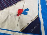a blue and white scarf with a red hat on it