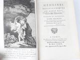 an open book with a picture of a woman holding a baby