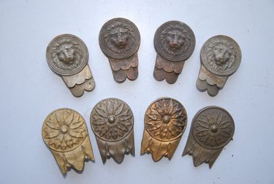 six antique brass door knobs with lion heads on them