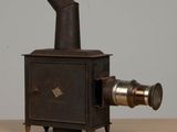 an old camera sitting on a wooden table