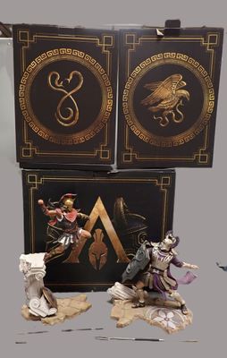 two figurines of a man and a woman with a sword and shield